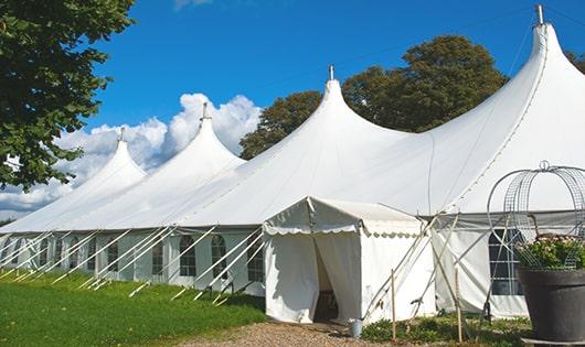 tall green portable restrooms assembled at a music festival, contributing to an organized and sanitary environment for guests in Bourbon