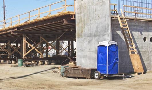 porta potties lined up neatly, ready to serve work site workers